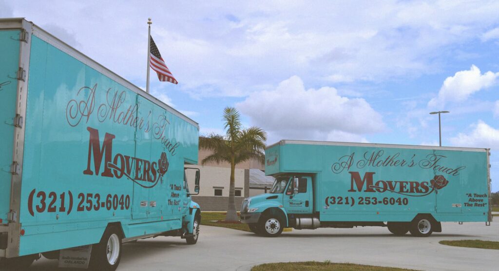 A Mother's Touch Movers Trucks in front of school